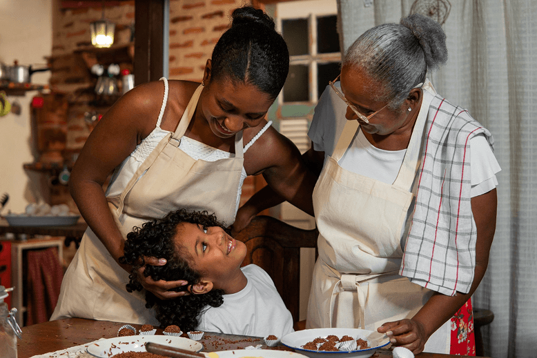 Happy family with nanny in kitchen